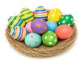 Colorful easter eggs in a basket, isolated on white background Royalty Free Stock Photo