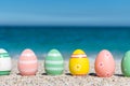 Colorful Easter eggs on the beach in sunny day. Royalty Free Stock Photo