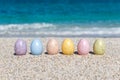 Colorful Easter eggs on the beach in sunny day. Royalty Free Stock Photo