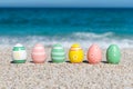 Colorful Easter eggs on the beach in sunny day. Royalty Free Stock Photo