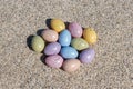 Colorful Easter eggs on the beach in sunny day. Royalty Free Stock Photo