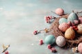 Colorful easter eggs on bird nest on blue background with copy space. Easter background Royalty Free Stock Photo
