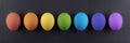 Colorful Easter eggs on a black stone background.Abstract easter concept,rainbow colors