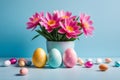 Colorful Easter eggs and blooming pink flowers on light blue background. Royalty Free Stock Photo