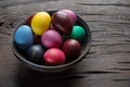 Colorful Easter eggs in bowl on wooden table. Attribute of Easter celebration Royalty Free Stock Photo