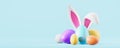 Colorful easter eggs with bunny ears on empty blue background Royalty Free Stock Photo