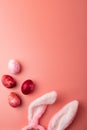 A colorful Easter eggs and a bunny or rabbit ears on pink background Royalty Free Stock Photo