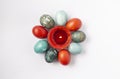 Colorful Easter eggs and burning wax candle. Traditional festive decor