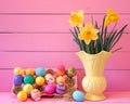 Colorful Easter Eggs in Carton with Vintage Yellow Vase filled with Spring Daffodils against Bright Pink Wood Board Background wit Royalty Free Stock Photo