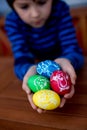 Colorful easter eggs with children drawings in child hands Royalty Free Stock Photo