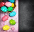 Colorful easter eggs and cutlery on a black background Royalty Free Stock Photo