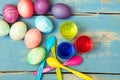 Colorful easter eggs, egg dyes and spoons on vintage wooden table Royalty Free Stock Photo