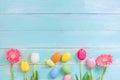 Colorful Easter eggs with flowers on rustic wooden background. Royalty Free Stock Photo