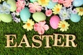 Colorful Easter eggs on grass with flowers Royalty Free Stock Photo