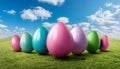 Colorful Easter Eggs on a grassfield with a clear blue sky with tiny clouds in the background Royalty Free Stock Photo