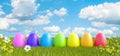 Colorful Easter Eggs on Green Meadow with Beautiful Blue Sky 3d render Royalty Free Stock Photo
