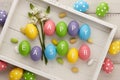 Colorful Easter eggs with letters on white planks Royalty Free Stock Photo