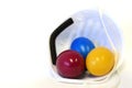 Colorful Easter eggs lie in a FFP2 mask in front of a white background