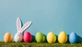 Colorful Easter eggs and lovely spring flowers on wooden background. Top view with copy space Royalty Free Stock Photo