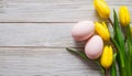 Colorful Easter eggs and lovely spring flowers on wooden background. Top view with copy space Royalty Free Stock Photo