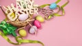 Colorful Easter eggs in the nest with text happy easter on pink background. Easter holiday concept Royalty Free Stock Photo