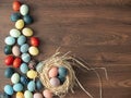 Colorful Easter eggs in nest on wooden table. Easter holiday decorations , Easter concept background Royalty Free Stock Photo