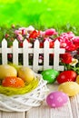 Colorful Easter eggs in the nest on wooden table and nature background Royalty Free Stock Photo