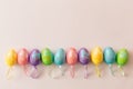 Colorful Easter eggs on pastel pink background. Easter decoration with space for text. Top view, flat lay, copy space