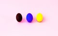 Colorful easter eggs on a pink background. Festive concept, minimalism. Close-up