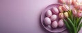 Colorful Easter eggs and pink tulips arranged on a pastel background for spring celebration Royalty Free Stock Photo