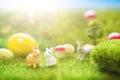 Colorful easter eggs and rabbits toy on fresh spring grass in the garden. Close up of easter bunny Royalty Free Stock Photo