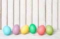 Colorful Easter eggs row on wood Royalty Free Stock Photo