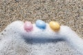 Colorful Easter eggs on the seaside in sunny day. Royalty Free Stock Photo