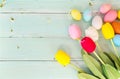 Colorful Easter eggs with tulip flower on rustic wooden planks background Royalty Free Stock Photo