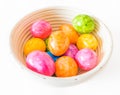 Colorful Easter eggs in a wooden bowl and white background Royalty Free Stock Photo