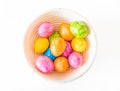 Colorful Easter eggs in a wooden bowl and white background Royalty Free Stock Photo