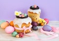 Colorful Easter spring stillife in soft light and trendy pastel colors. Traditional cake with chocolate nest, candy and qail eggs