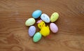 Colorful Easter toy eggs and a yellow toy chicken on a wooden background.The Concept Of Easter Royalty Free Stock Photo