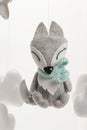 Colorful and eco-friendly children`s mobile from felt. A felt toy in the form of a lovely fox, part of a children`s mobile. On a