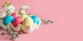 Colorful eggs with spring flowers on pink. Easter. Close up Royalty Free Stock Photo