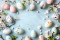 Colorful eggs with sprinkles and flowers on blue surface. Perfect for Easter celebrations and spring Royalty Free Stock Photo