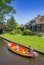 Colorful electric motorboat in the historic canal of Giethoorn