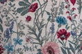 Colorful embroidered floral pattern texture on textile front view