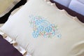 Colorful embroidery design on a white pillow