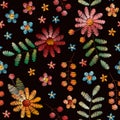 Colorful embroidery seamless pattern. Bright flowers, leaves and berries on black background. Beautiful fancywork Royalty Free Stock Photo