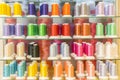 Colorful embroidery thread spool using in garment industry, row of multicolored yarn rolls, sewing material selling in the market.