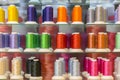 Colorful embroidery thread spool using in garment industry, row of multicolored yarn rolls, sewing material selling in the market.