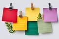 Colorful empty notes with clips and green leaves Royalty Free Stock Photo