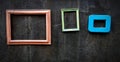 Colorful empty picture frame hanging or isolated on black rough black wall for decoration Royalty Free Stock Photo