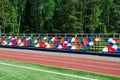 Colorful empty stands in a stadium. Red, blue, green, white, orange plastic seats. Royalty Free Stock Photo